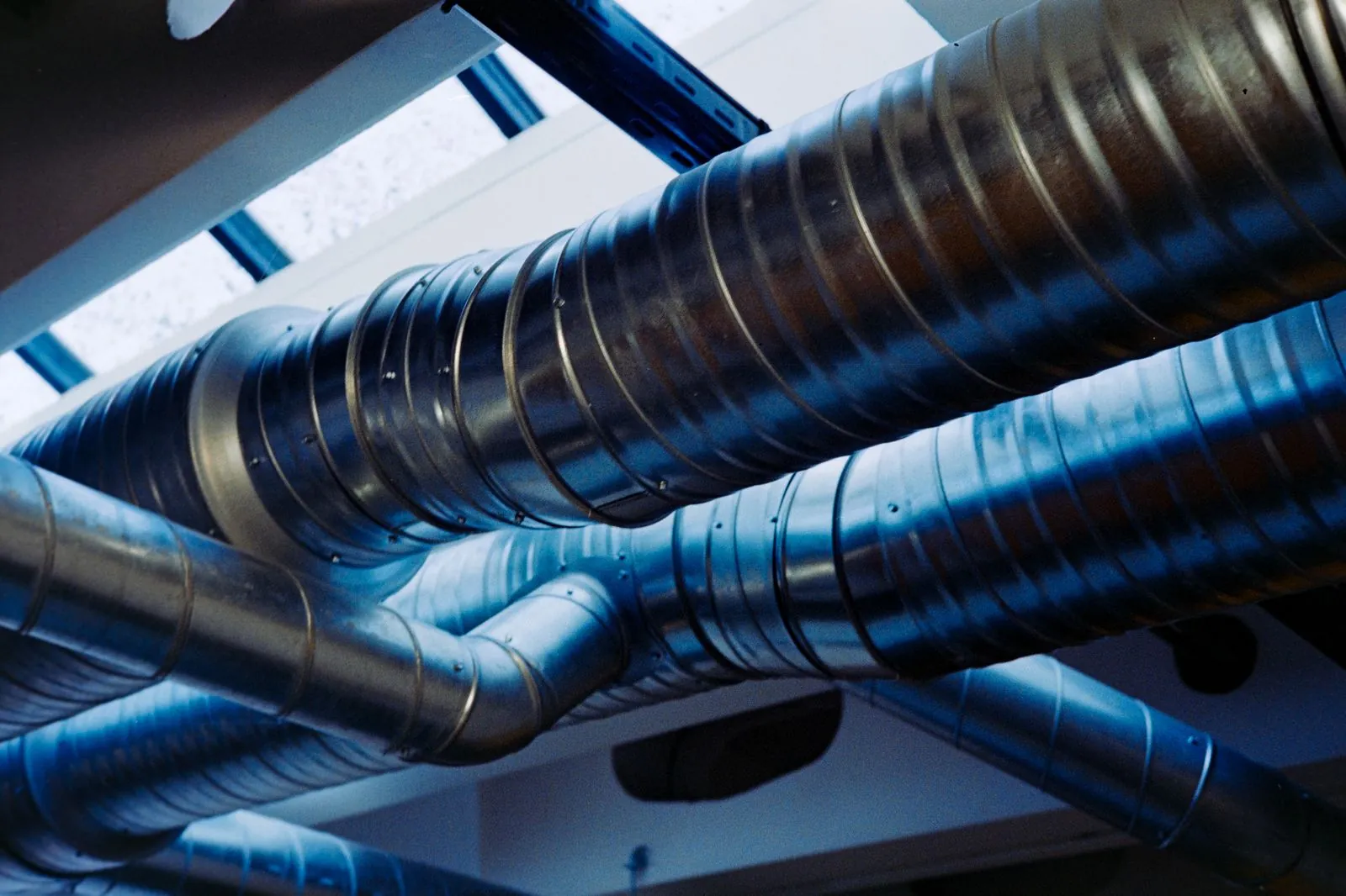 Rows of large-tonnage cooling equipment on an industrial rooftop